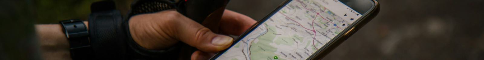 walker holding iphone with map
